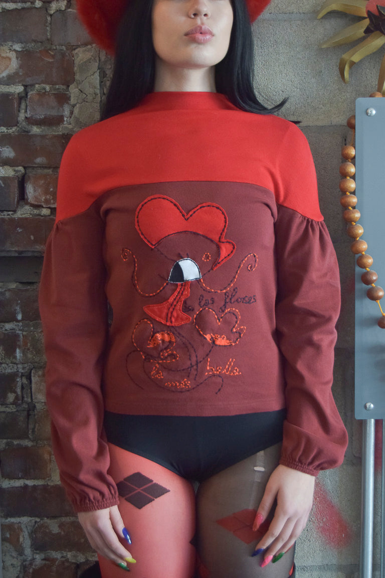 AVISPADA TWO TONED RED MOCK NECK SWEATER WITH STATEMENT EMBROIDERY