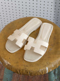 HERMES CREAM LEATHER LOGO SANDALS